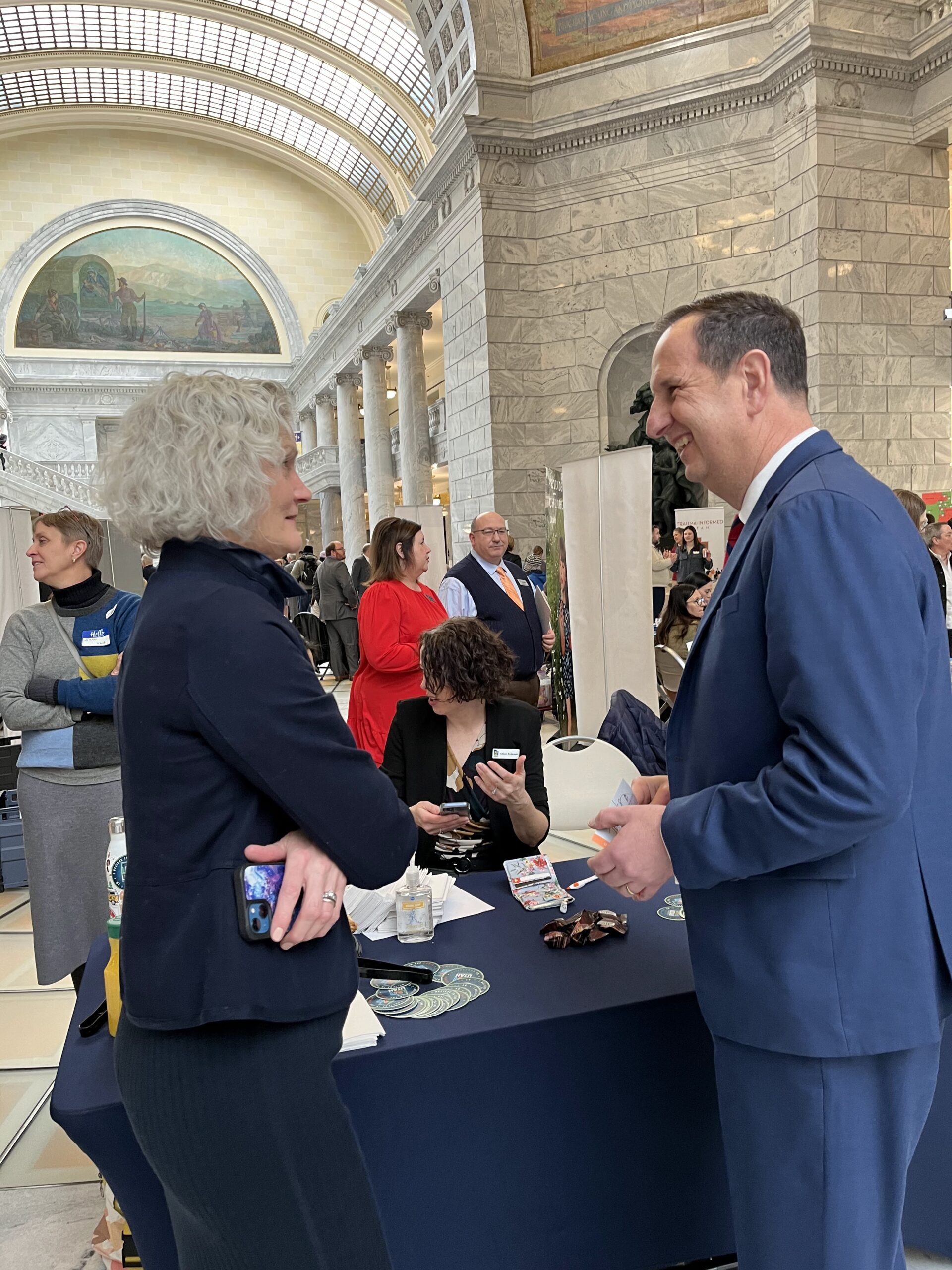 Rep. Thurston talking with a woman in the rotunda of the state capitol